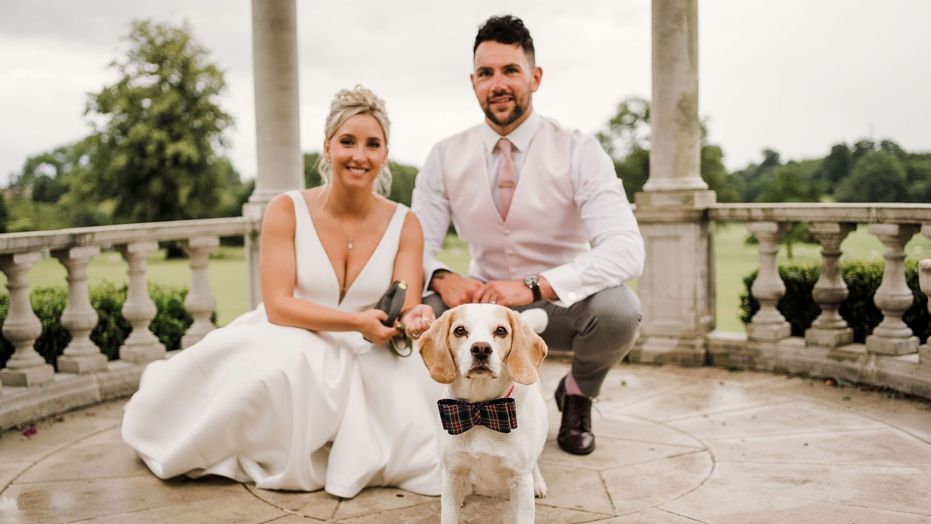 A bride & groom with their dog beneath the Dome at Froyle Park