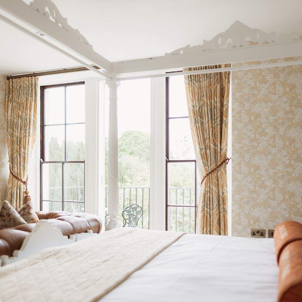 Four-poster bed in the Honeymoon Suite at Froyle Park, a romantic wedding night stay in Surrey