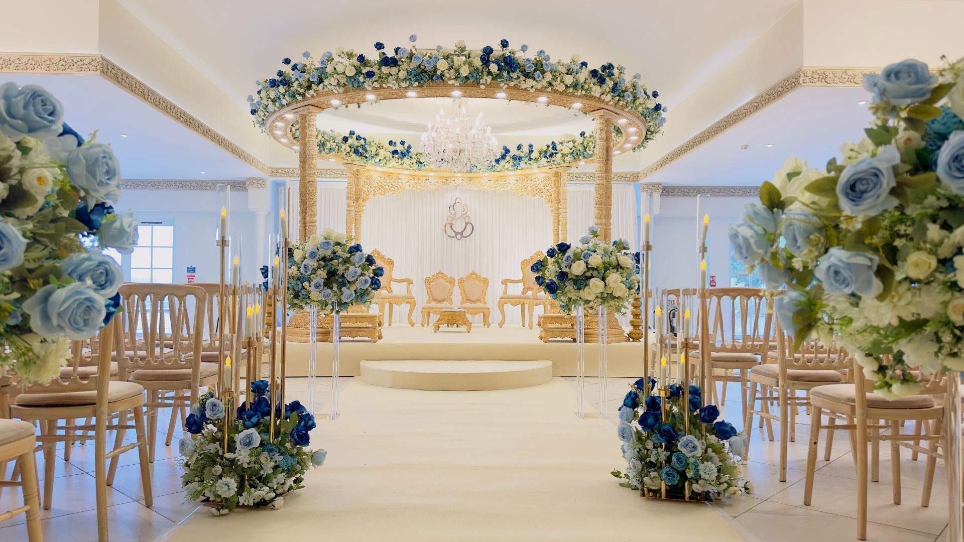 A blue & gold Asian Wedding Mandap setup in Froyle Park's Grand Ballroom - a multi-award winning Asian wedding venue just an hour from London on the Surrey / Hampshire border.