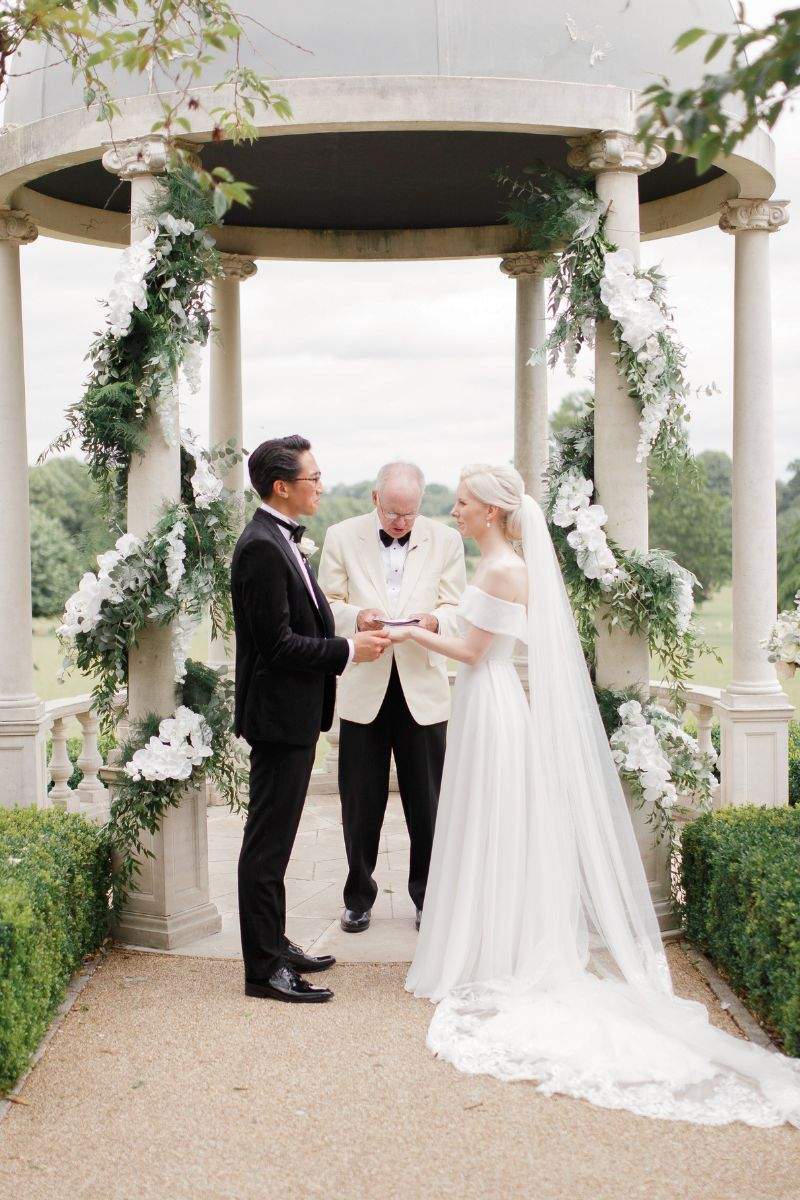 A British couple getting married at the outdoor dome at Froyle Park in Hampshire - a top rated wedding venue that offers all0inclusive catering packages in partnership with caterer Kalm Kitchen.