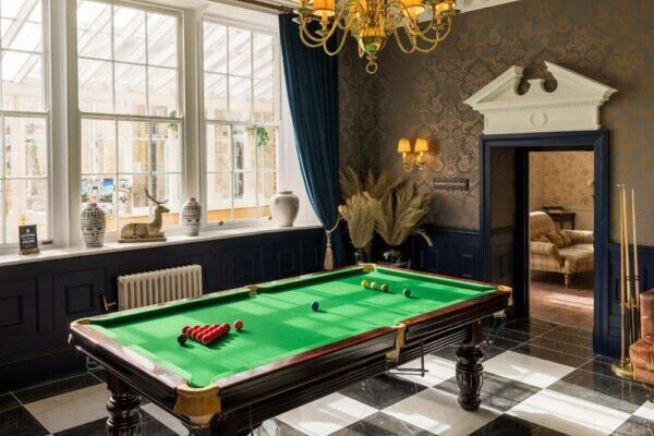 The Groom's Lounge is a getting ready space that benefits from a snooker table and decadent decor