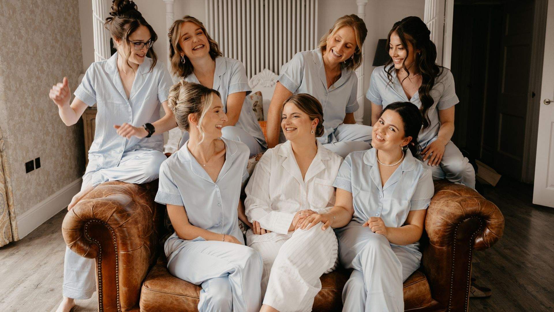 A Bride and her bridesmaids relax in matching pyjamas in the Bridal Suite at Froyle Park