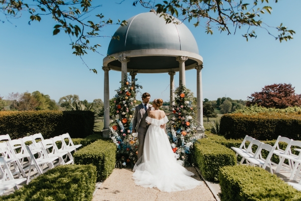 A Bride & Groom posing at Froyle Park following their church ceremony in Hampshire.