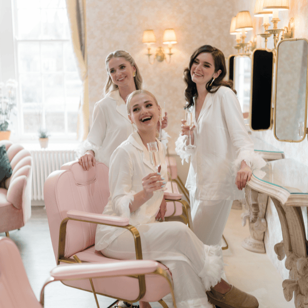 A bride and her bridesmaids begin wedding preparations in the Hideaway at Froyle Park