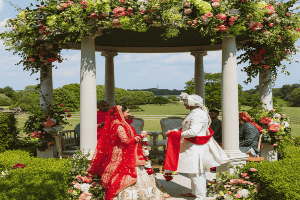 A beautiful outdoor Hindu wedding ceremony underneath a Mandap at Froyle Park - a wedding Venue in Surrey, just an hour from London, specialising in dry hire Asian weddings.