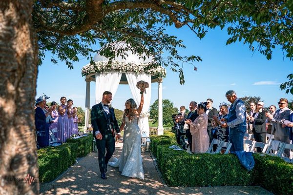 Bride and groom during an outdoor wedding ceremony at Froyle Park