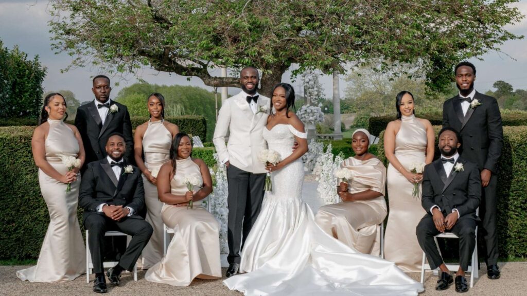 Bride and Groom with their party in the gardens at Froyle Park