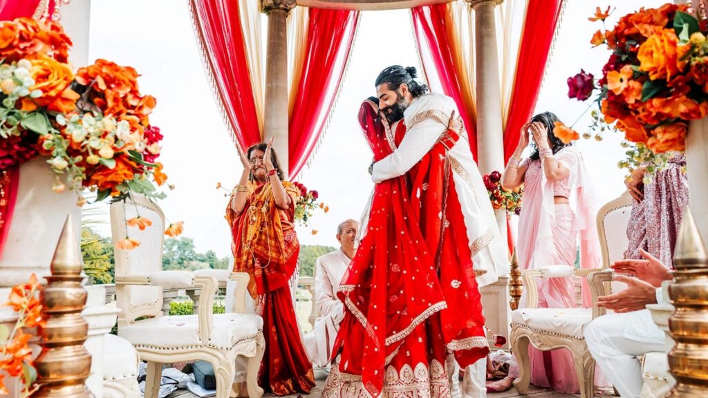 A Hindu Bride and Groom benath their outdoor Mandap at Froyle Park
