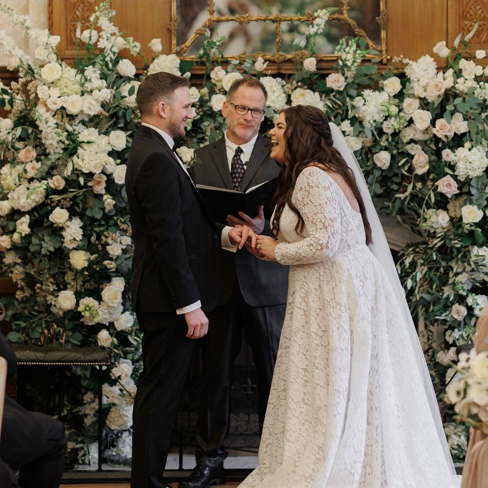 Bride and Groom exchange vows joylfully in The Great Hall at Froyle Park